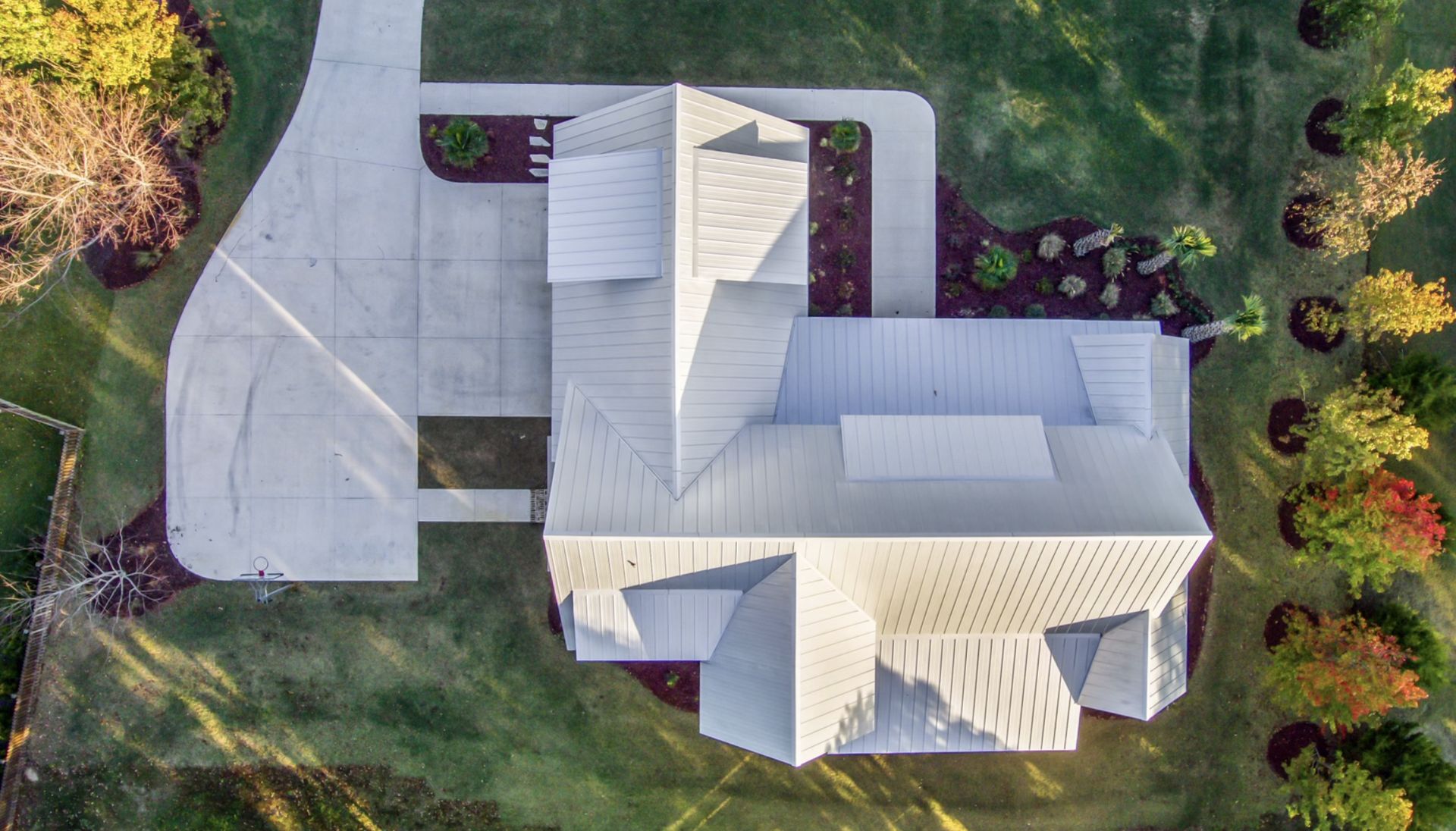 Aerial view of a bright white roof system on a coastal home