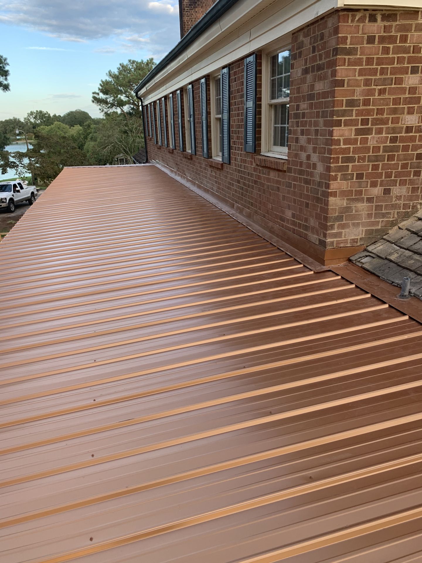 Copper-tone metal roof on brick home