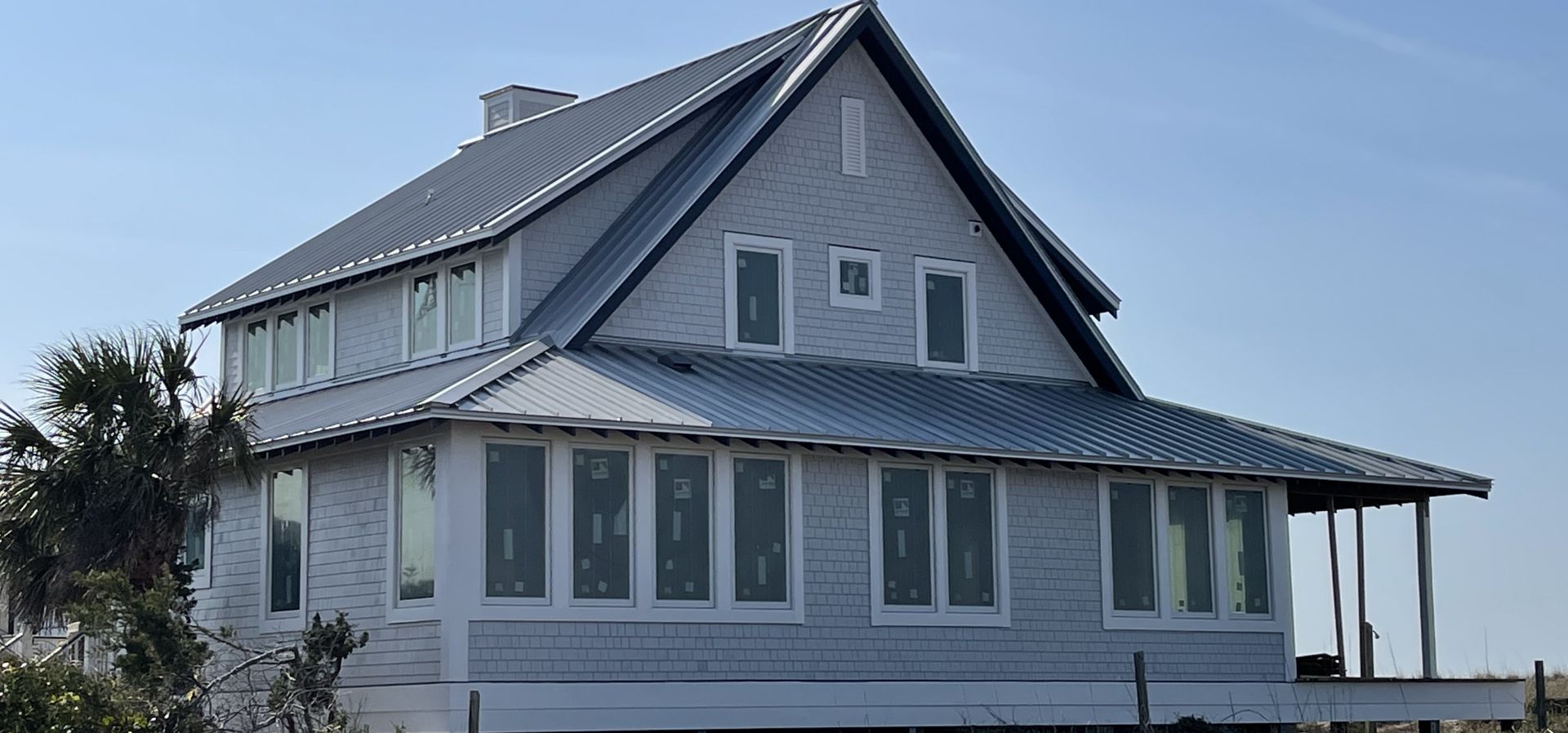 Gray farmhouse with new roofing