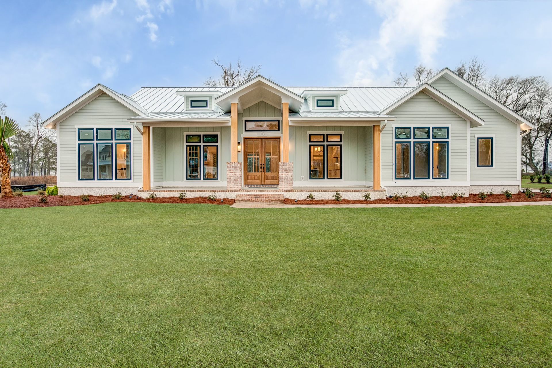 Single-story ranch home with white metal roof