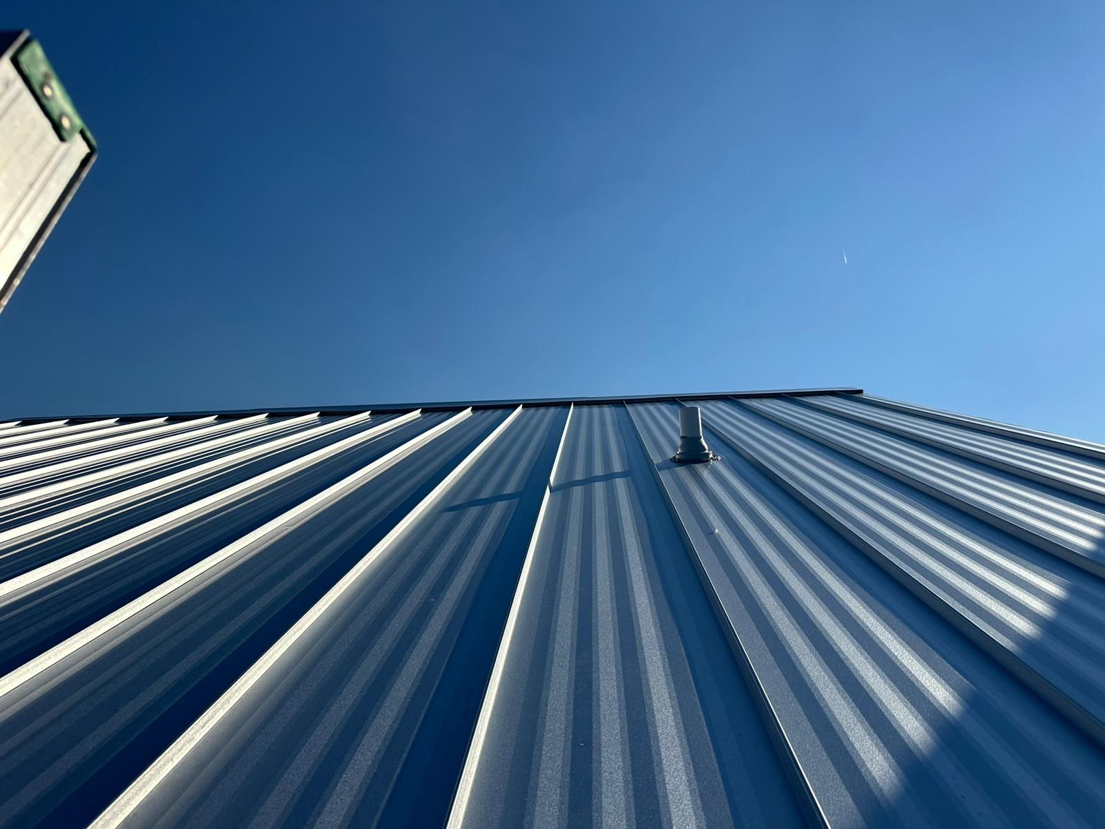 Metal roofing panels against a blue sky