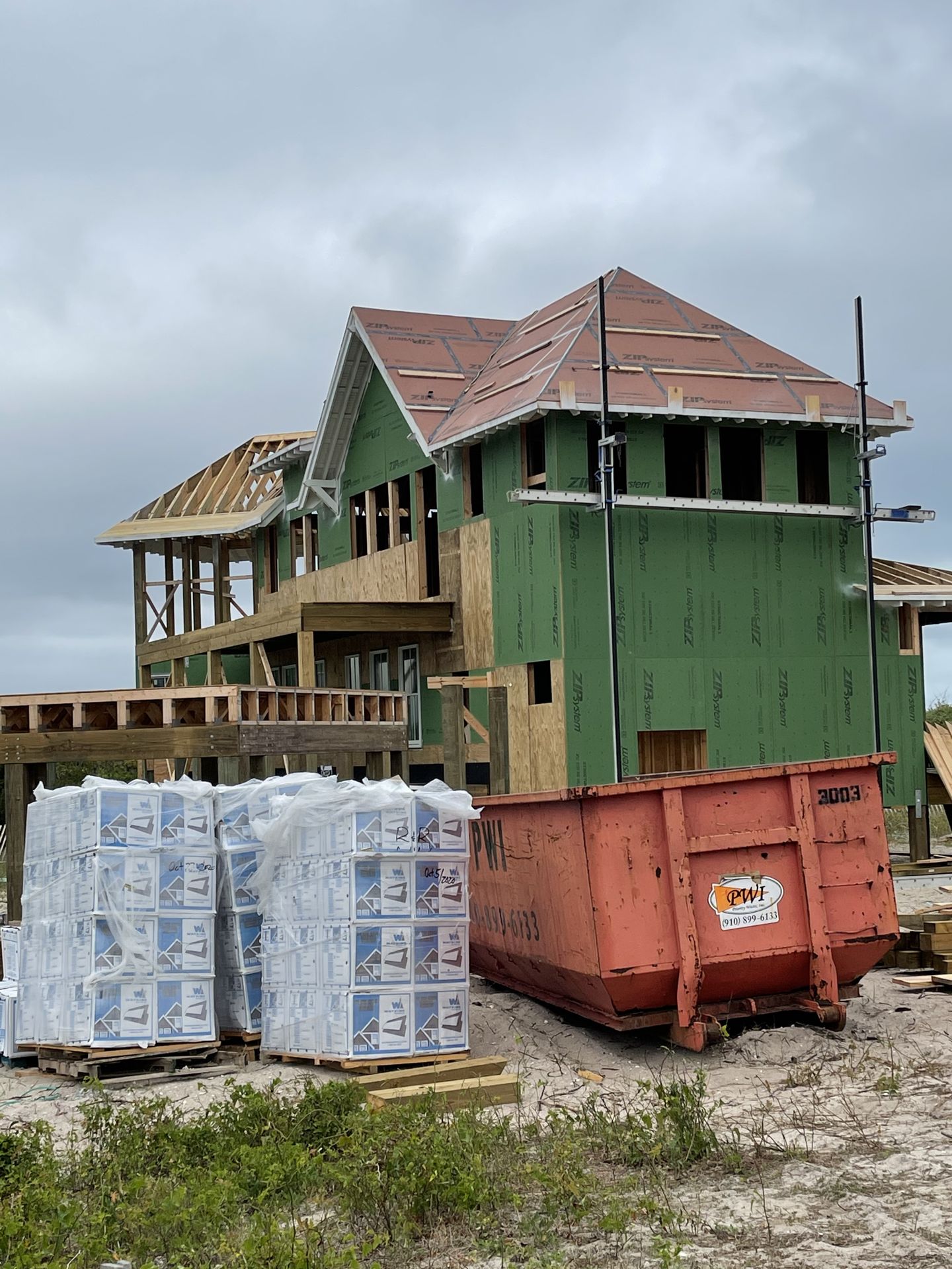 Pallets of roofing shingles staged at a job site