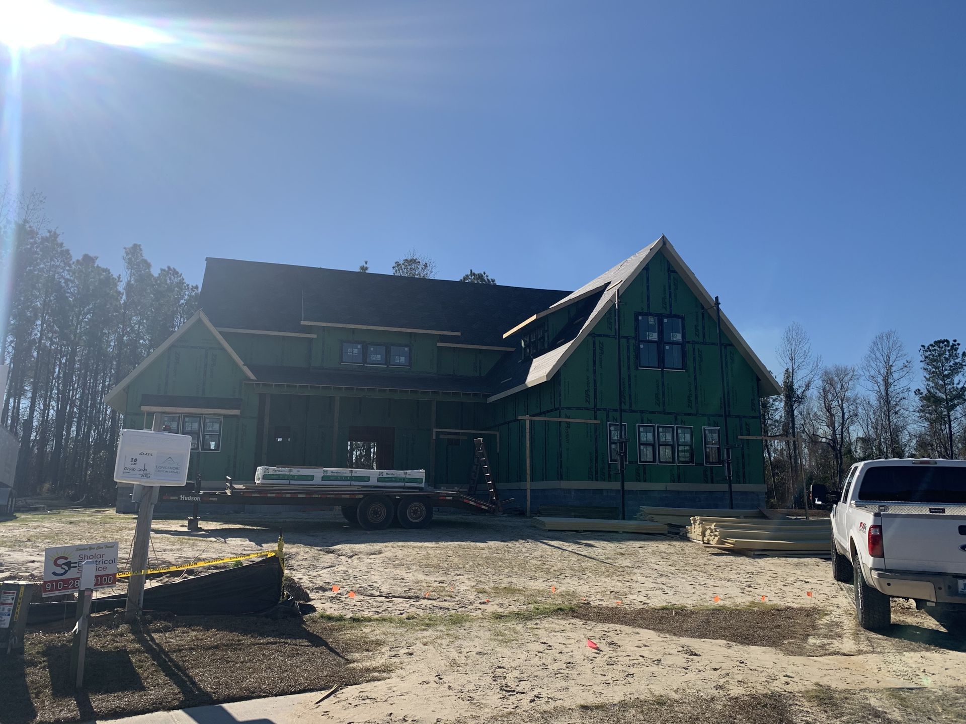 New home under construction with fresh roof decking